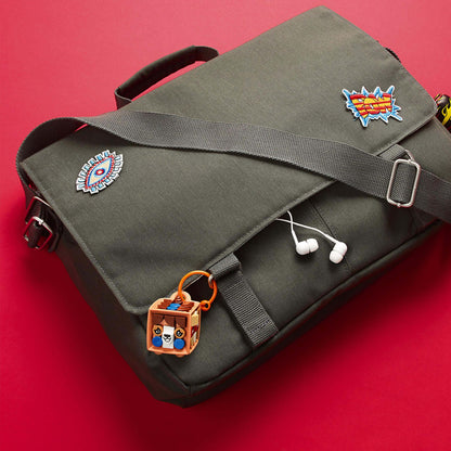 LEGO® DOTS Dog Bag Tag Kit 41927 attached to a green messenger bag with earphones, showcasing fun arts and crafts creativity.