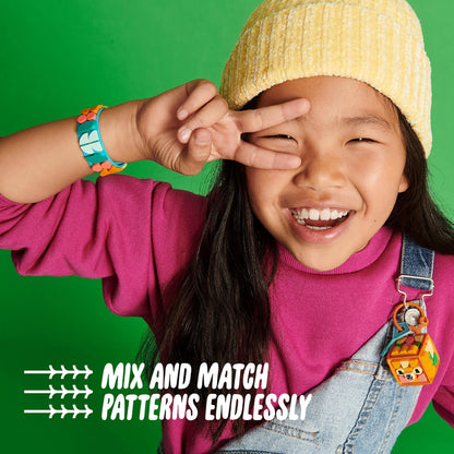 Girl showcasing LEGO® DOTS bracelet and bag tag with playful expressions, highlighting creativity and fun.