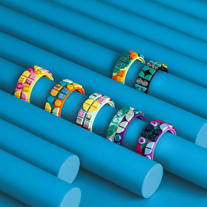 Colorful LEGO® DOTS music bracelets displayed on a bright blue background, showcasing creativity for kids.