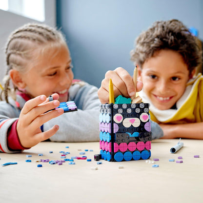 Kids enjoying the LEGO® DOTS Secret Holder set, creating colorful room decor with tiles and a secret drawer.