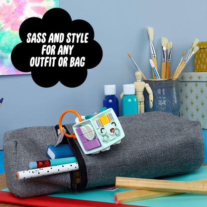 LEGO DOTS unicorn bag tag kit displayed on a gray pencil case with art supplies, showcasing fun and creativity.