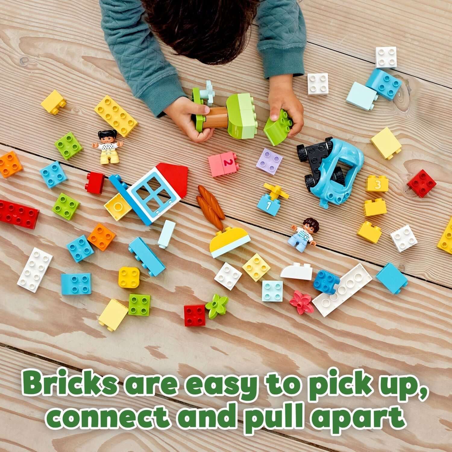 Child playing with colorful LEGO® DUPLO bricks, showcasing creative play and easy connectivity for toddlers.