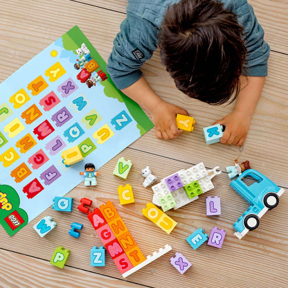 Child playing with LEGO® DUPLO Alphabet Truck set, colorful blocks, and alphabet cards, engaging in creative learning.