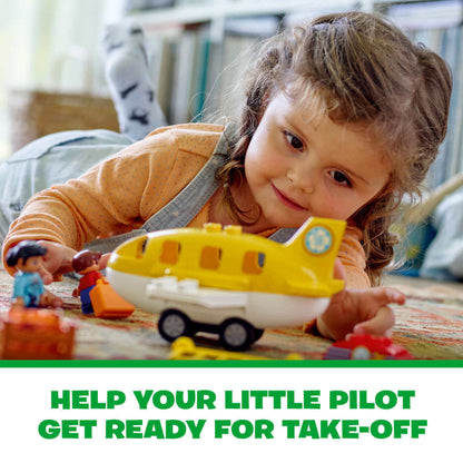 Child playing with LEGO DUPLO airport set, preparing the plane for take-off with colorful building blocks.