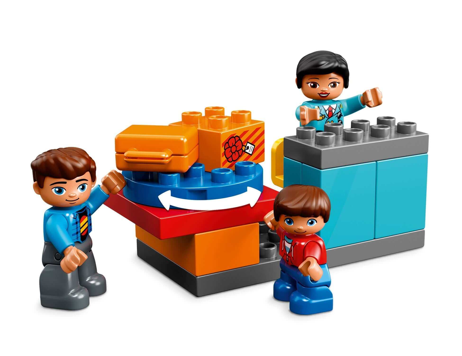 Two children playing with the LEGO® DUPLO My Town Airport Building Set, featuring a luggage slide and colorful building blocks.