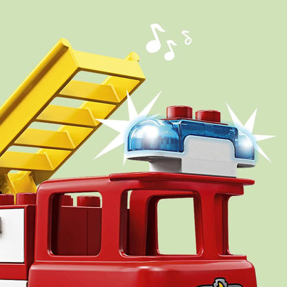 Close-up of LEGO® DUPLO fire truck with lights and sounds, featuring a yellow ladder and emergency beacon.