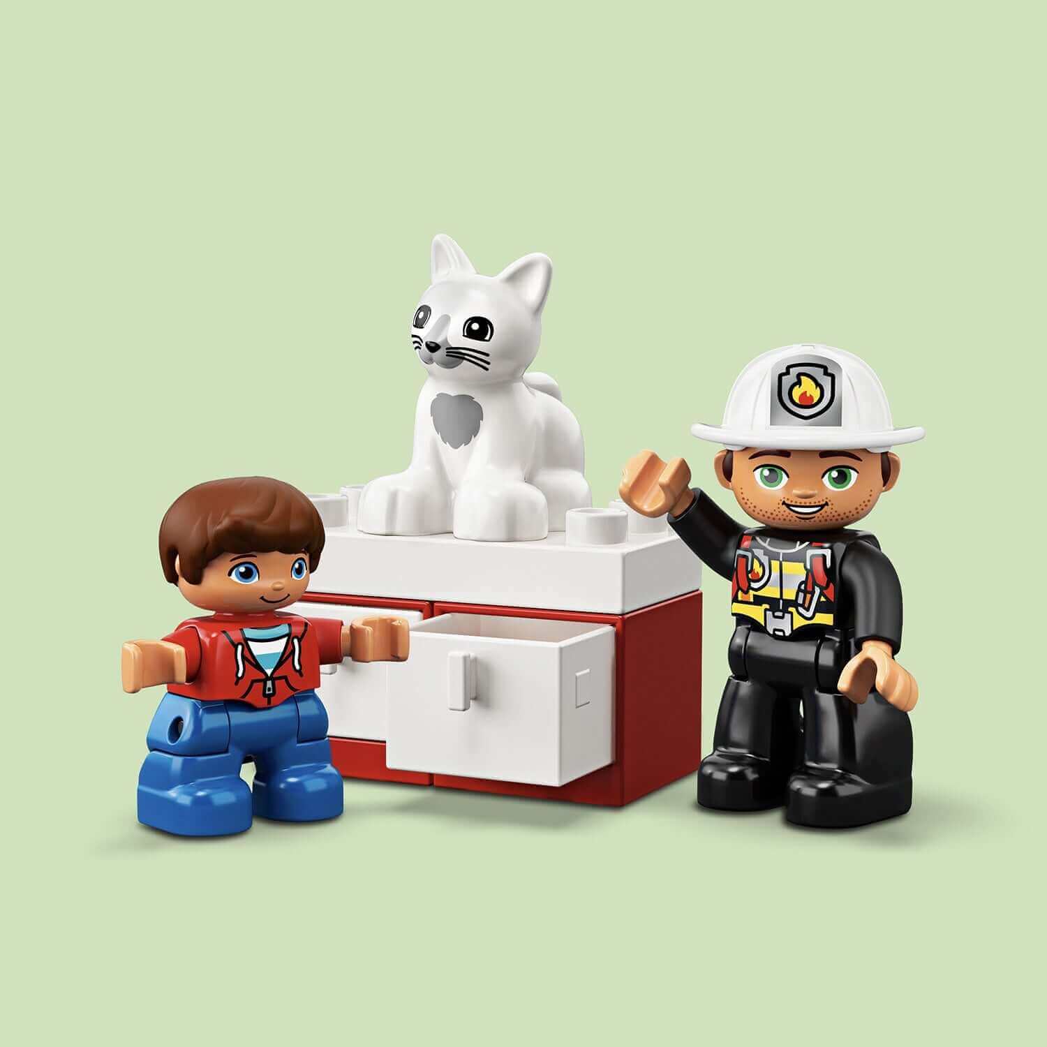 LEGO® DUPLO Town Fire Truck set features a firefighter and toddler with a cat on a cabinet, promoting imaginative play.
