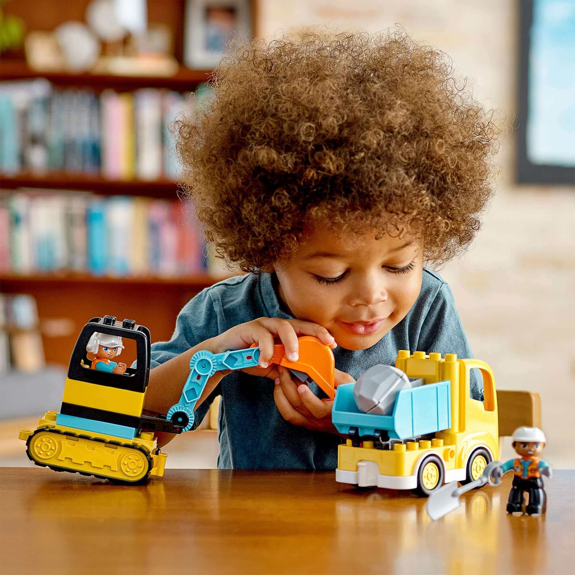 Child playing with LEGO® DUPLO Truck and Excavator set, enhancing creativity and construction skills.