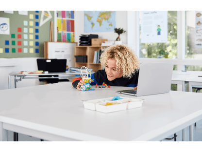 Student engaging with LEGO Education SPIKE Essential set in a classroom setting, fostering hands-on STEAM learning.