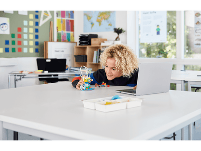 Student engaging with LEGO Education SPIKE Essential set in a classroom setting, fostering hands-on STEAM learning.