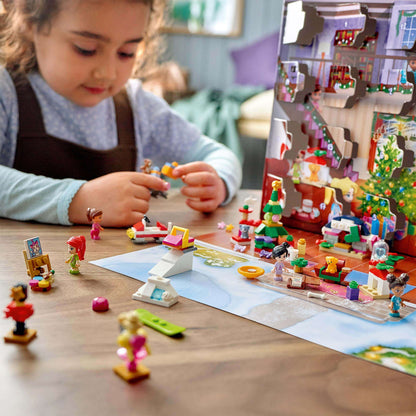 Child playing with LEGO Friends Advent Calendar, featuring characters and festive decorations for a joyful Christmas countdown.