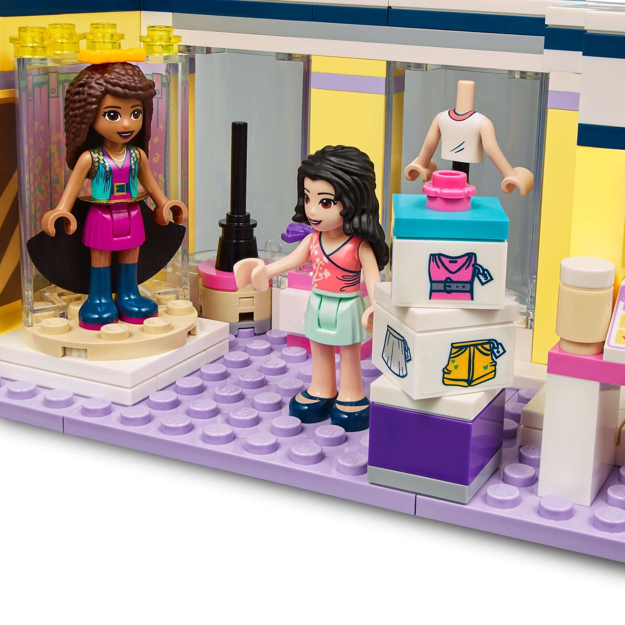 LEGO Friends Emma's Fashion Shop playset with mini-dolls showcasing outfits and fashion items in a vibrant store interior.