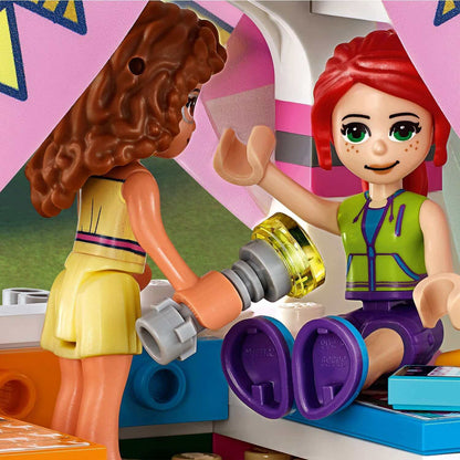 LEGO Friends Nature Glamping Set 41392 features kids playing indoors with a flashlight in a colorful tent, enjoying nature adventures.