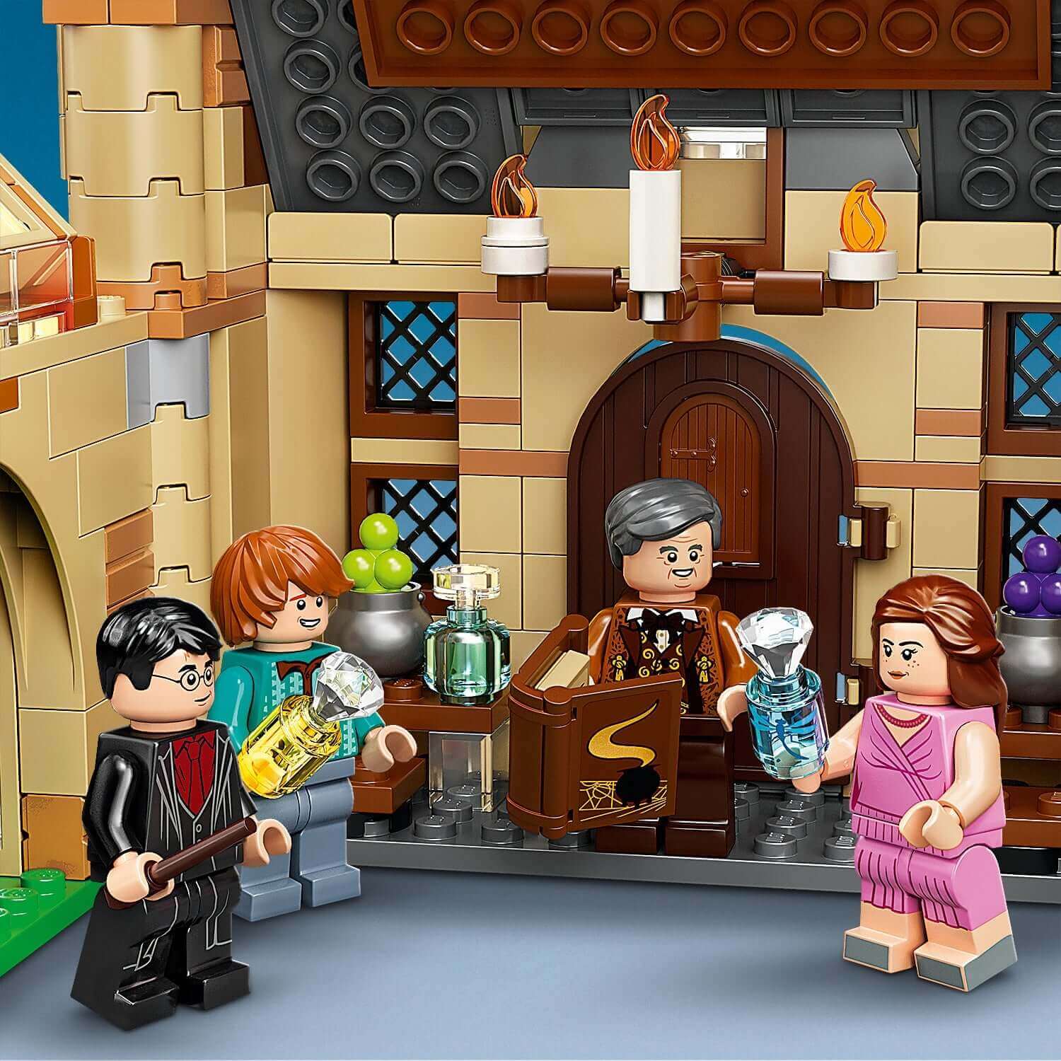 LEGO Harry Potter Astronomy Tower Set with characters holding potions near the Hogwarts entrance.