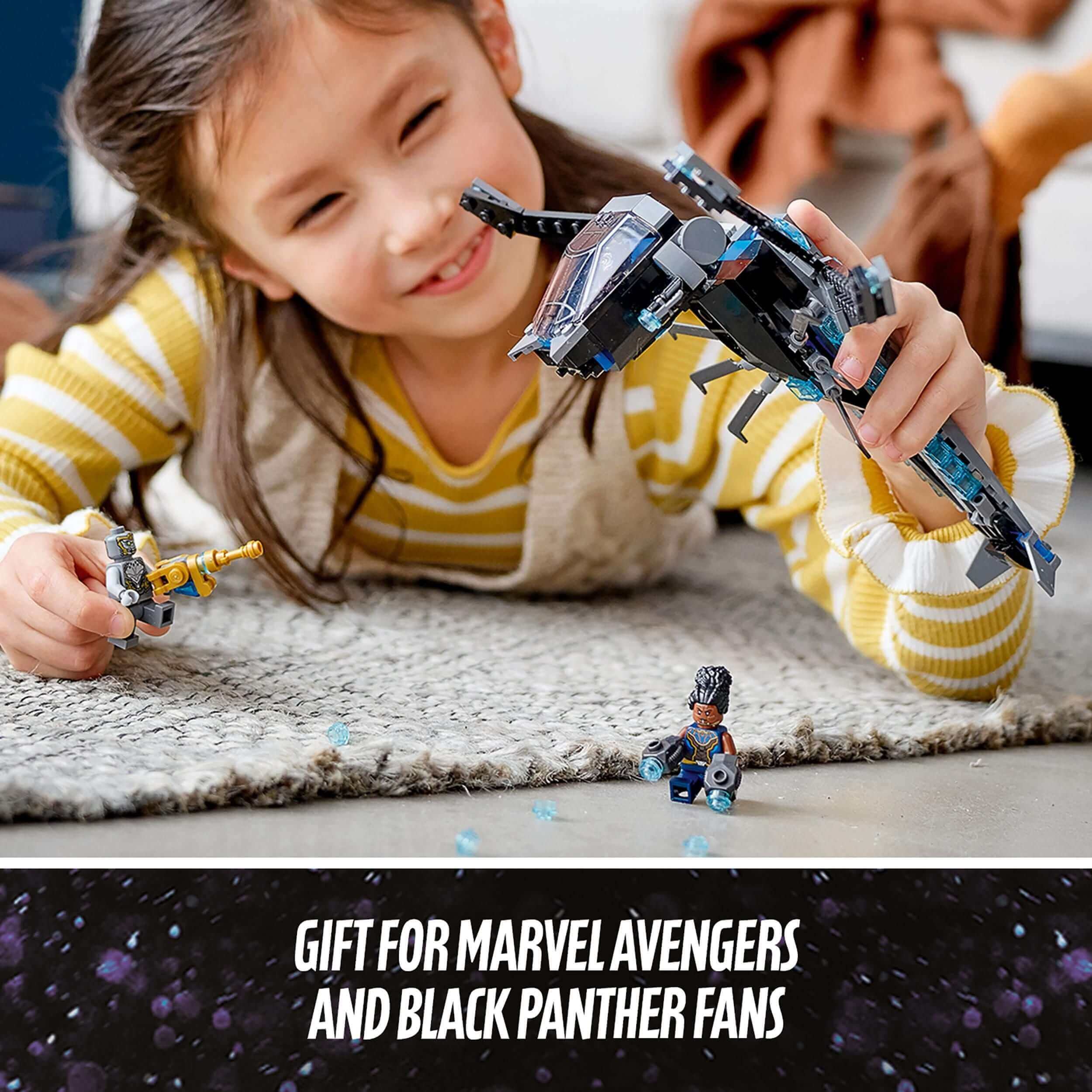 Child playing with LEGO® Marvel Black Panther Dragon Flyer set, perfect gift for Avengers fans.