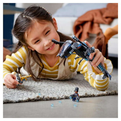 Young girl playing with LEGO® Marvel Black Panther Dragon Flyer set 76186, featuring iconic dragon aircraft and characters.