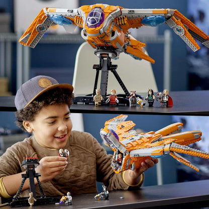 Child playing with LEGO® Marvel Guardians' Ship set, featuring iconic spaceship and superheroes.