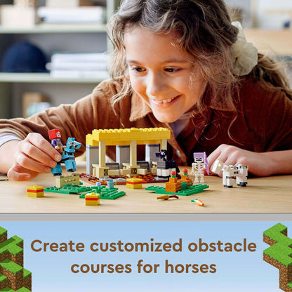 Child playing with LEGO® Minecraft The Horse Stable Farm Toy, building obstacle courses for horses.