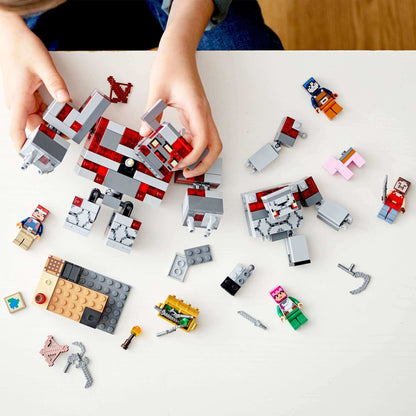 Child assembling LEGO Minecraft The Redstone Battle Set 21163 with characters and accessories on a table.