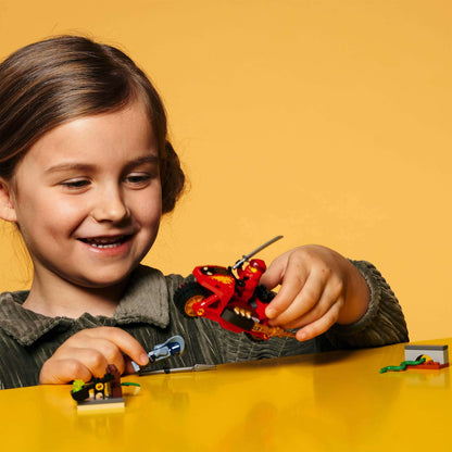 Child playing with LEGO® NINJAGO Kai’s Blade Cycle set, featuring a red motorcycle and ninja minifigures.
