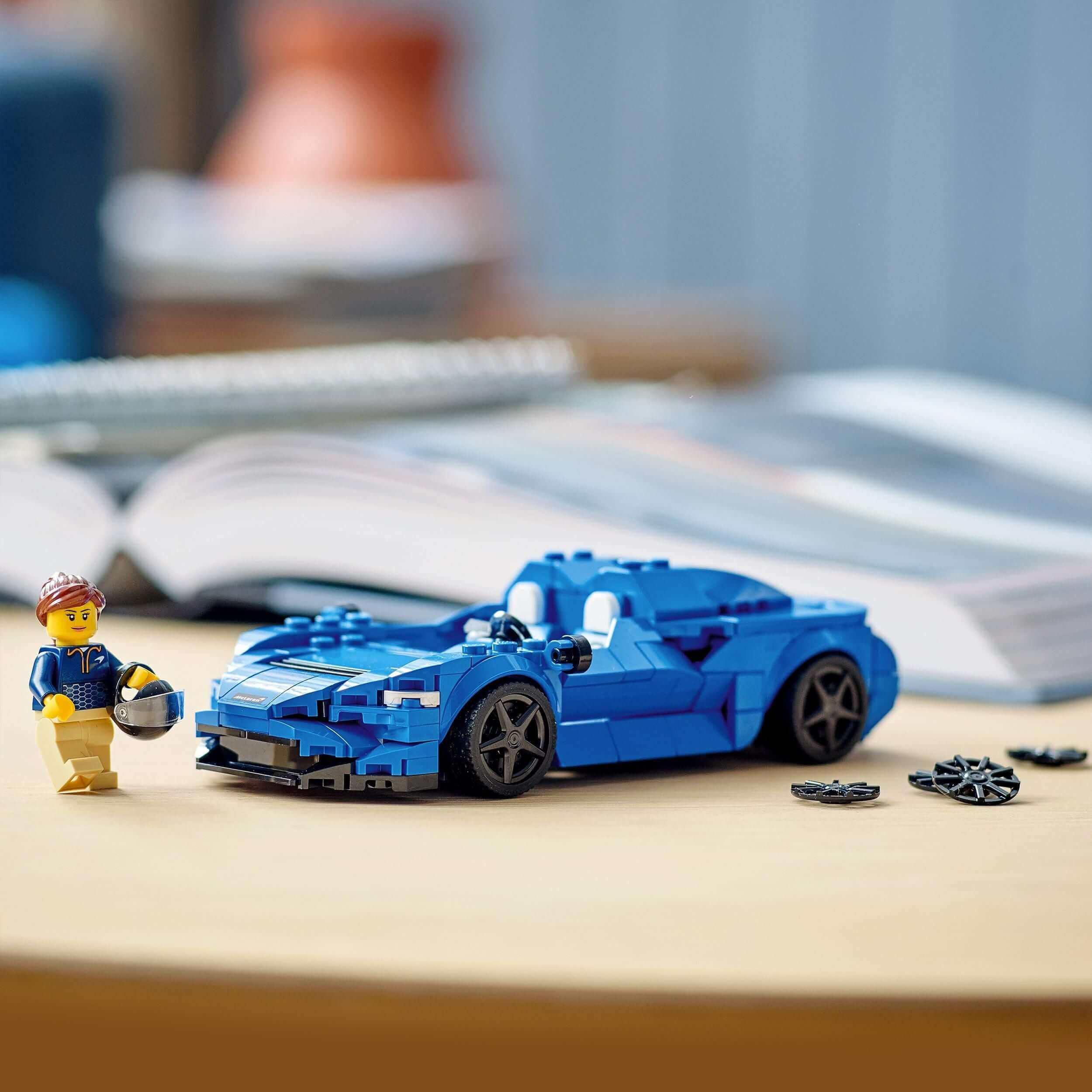 LEGO® Speed Champions McLaren Elva model with mini figure and accessories on a table.