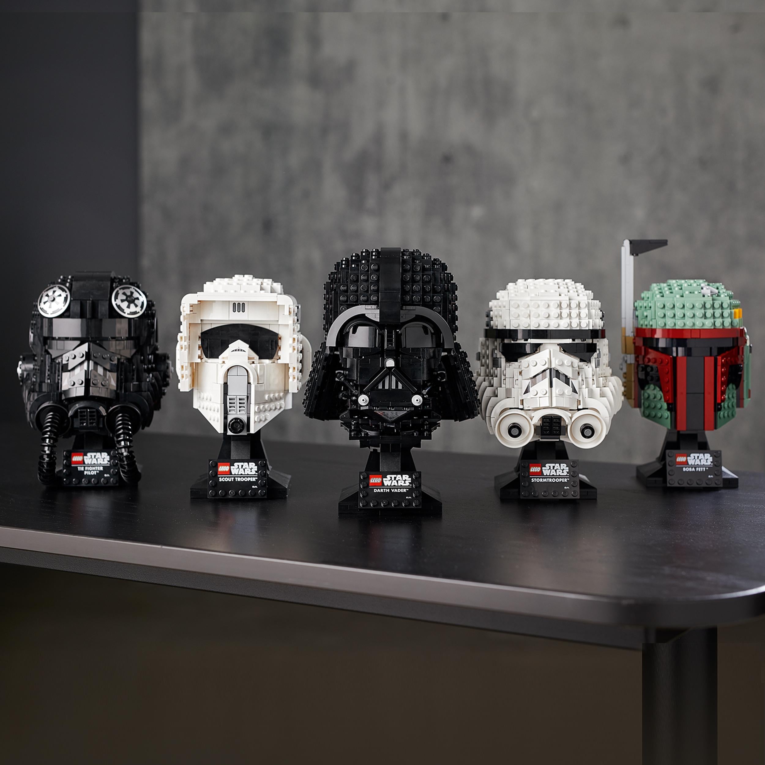 LEGO® Star Wars collectible helmets including Scout Trooper, Darth Vader, and Boba Fett on display.