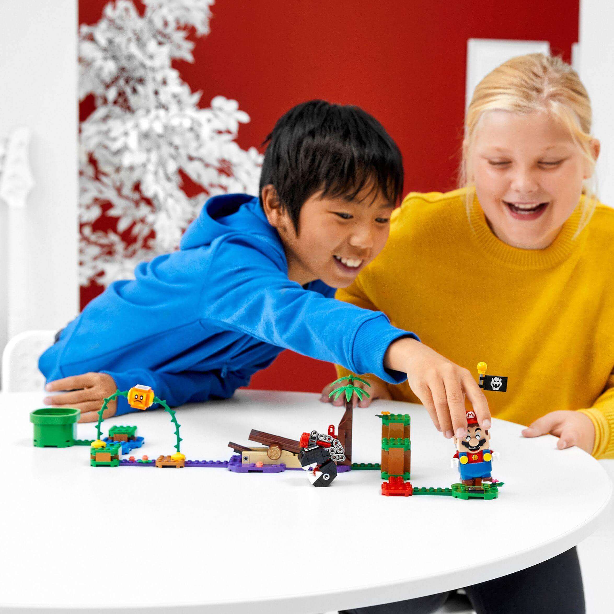 Kids playing with LEGO® Super Mario Jungle Encounter Expansion Set 71381, enjoying creative building and gaming.