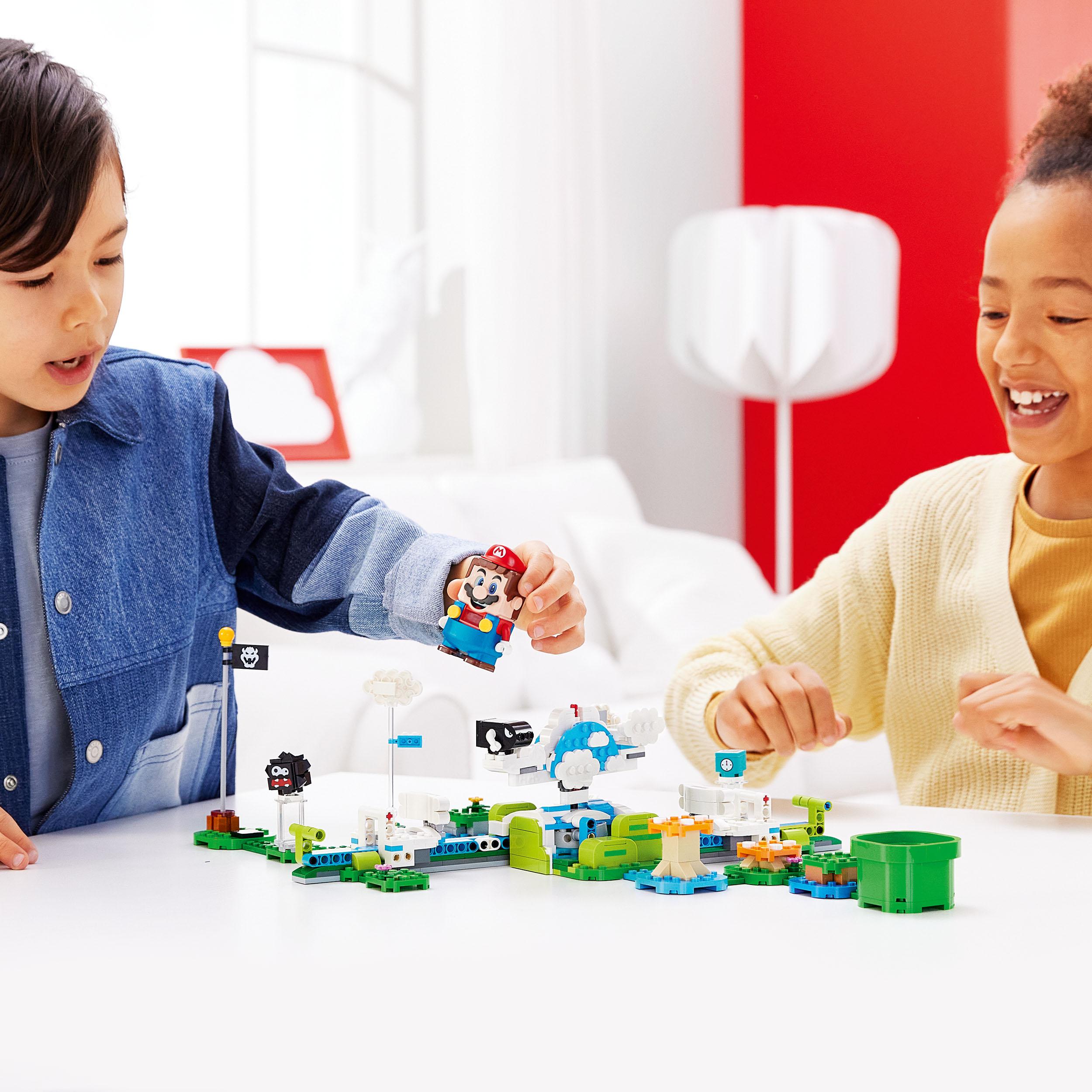 Kids playing with LEGO® Super Mario Lakitu Sky World Expansion Set 71389, featuring fun LEGO® figures and colorful scenery.