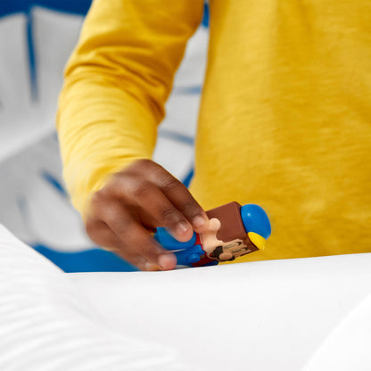 Child playing with LEGO® Super Mario Penguin Mario figure from Power-Up Pack 71384.