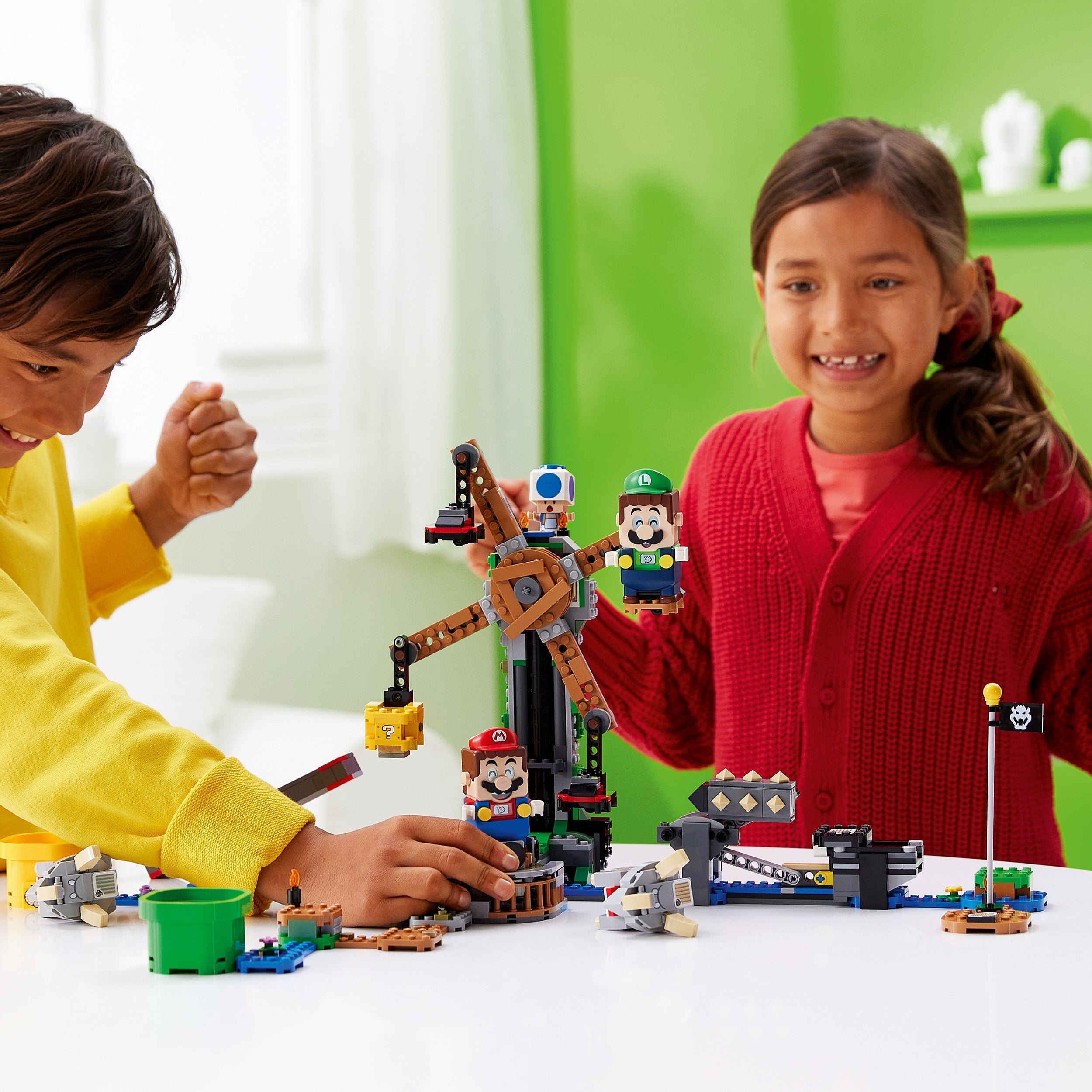 Kids enjoying LEGO® Super Mario Reznor Knockdown Expansion Set 71390, featuring interactive play with Mario and Luigi.