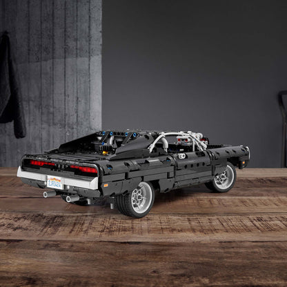 LEGO® Technic Dom's Dodge Charger F&F Set 42111, black car model showcasing detailed rear design on a wooden surface.