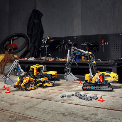 LEGO Technic Heavy-Duty Excavator and crawler model on a workshop table, perfect for construction vehicle enthusiasts.