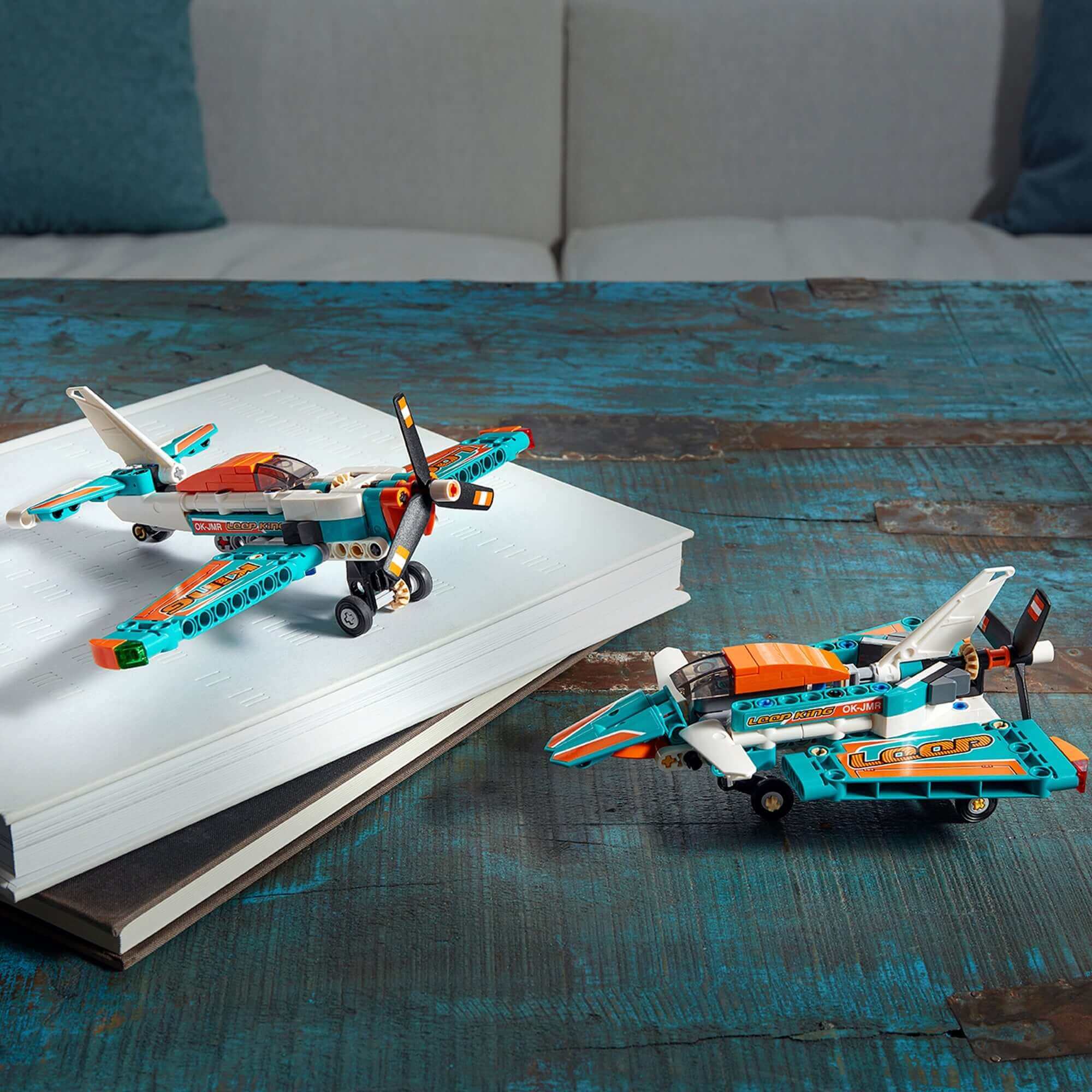 LEGO® Technic Race Plane Jet 2-in-1 toy 42117 displayed on a table, showcasing both plane models with vibrant colors.