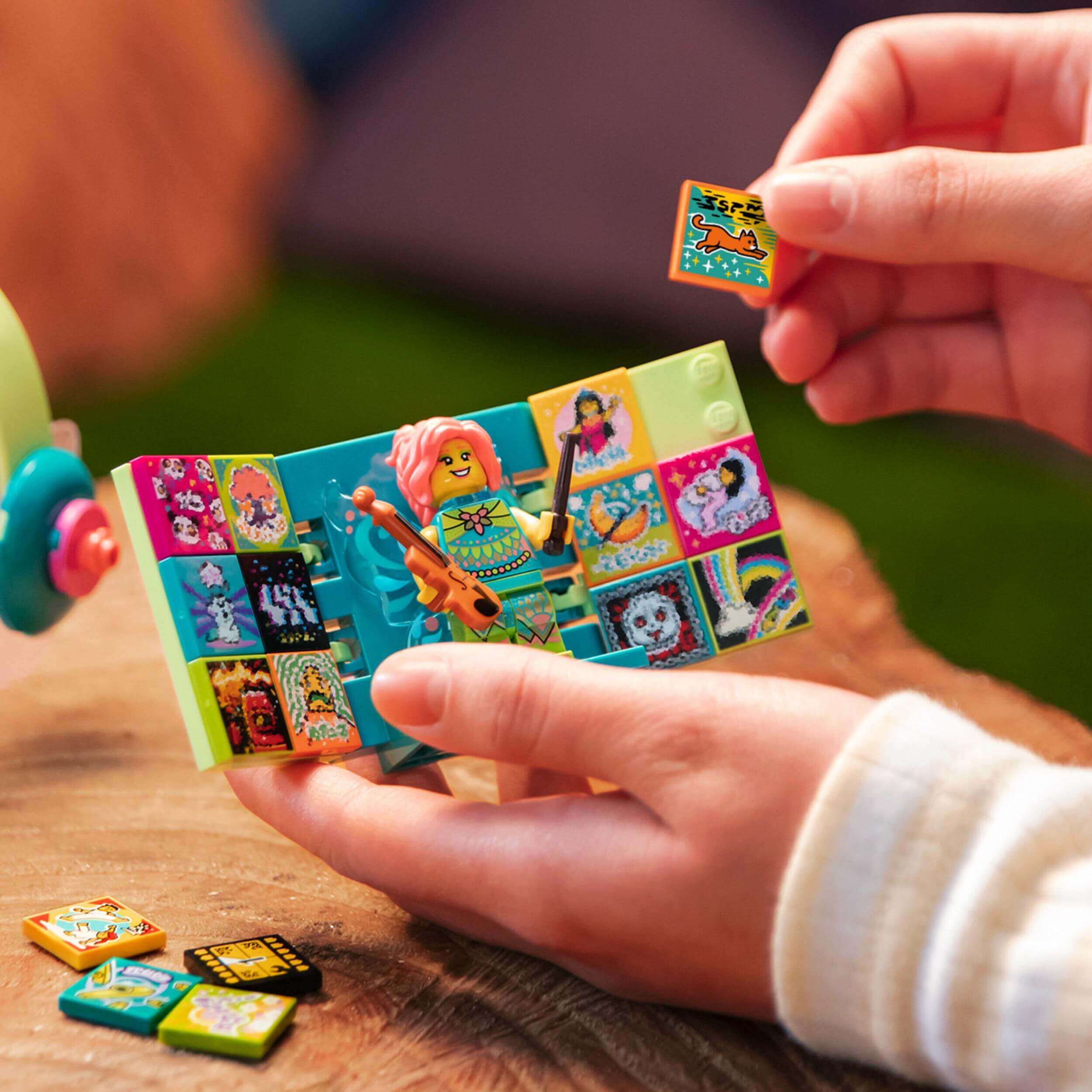 Child using LEGO® VIDIYO Folk Fairy BeatBox to create music videos with colorful tiles and character.