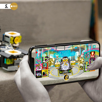 Child using smartphone to create music video with LEGO® VIDIYO Robo HipHop Car set, colorful app interface visible.