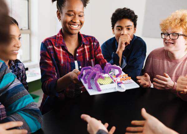 Students engaging with littleBits Code Kit, showcasing a physical invention in a classroom setting.