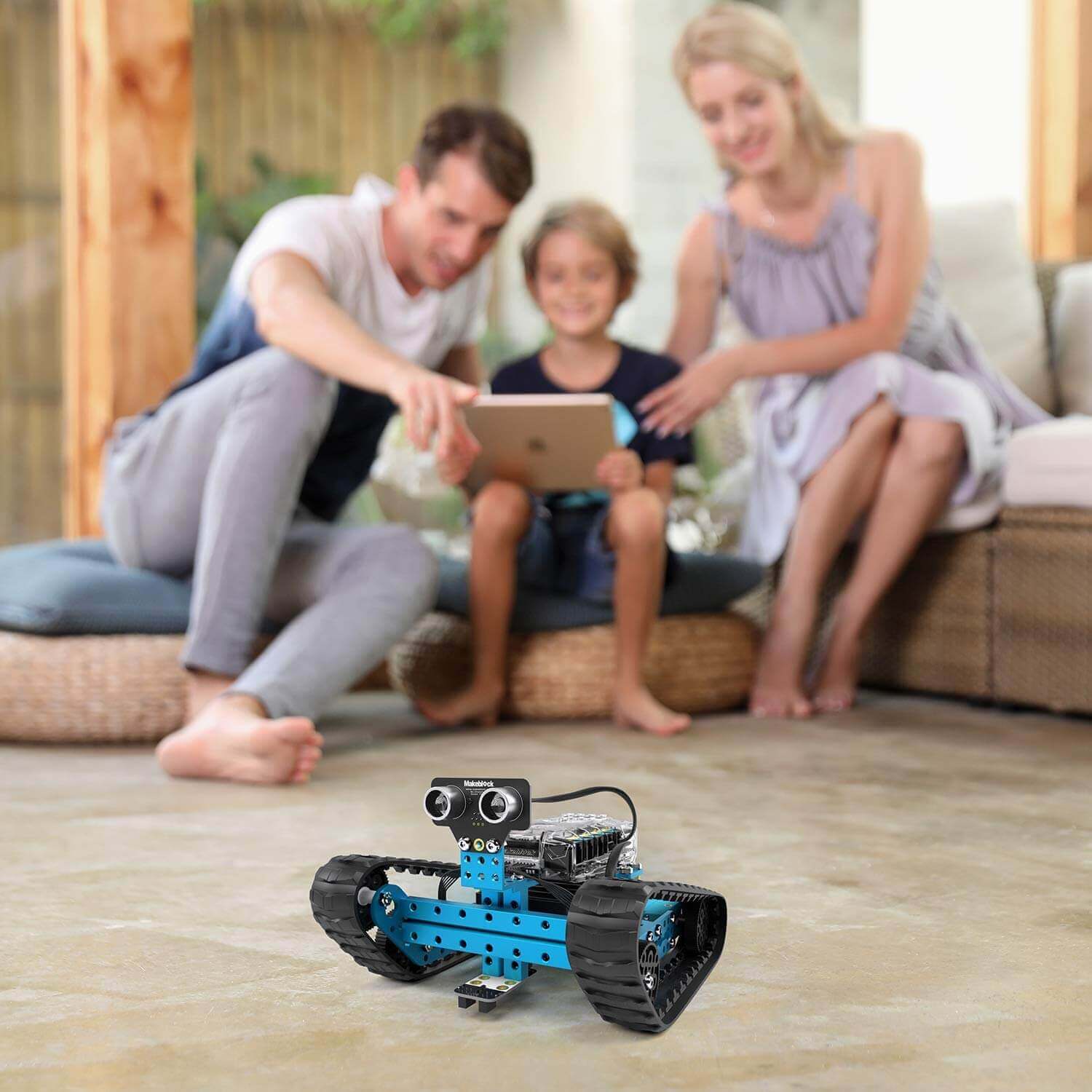 Family enjoying playtime with Makeblock mBot Ranger Robot Kit, showcasing its Bluetooth control and fun educational features.