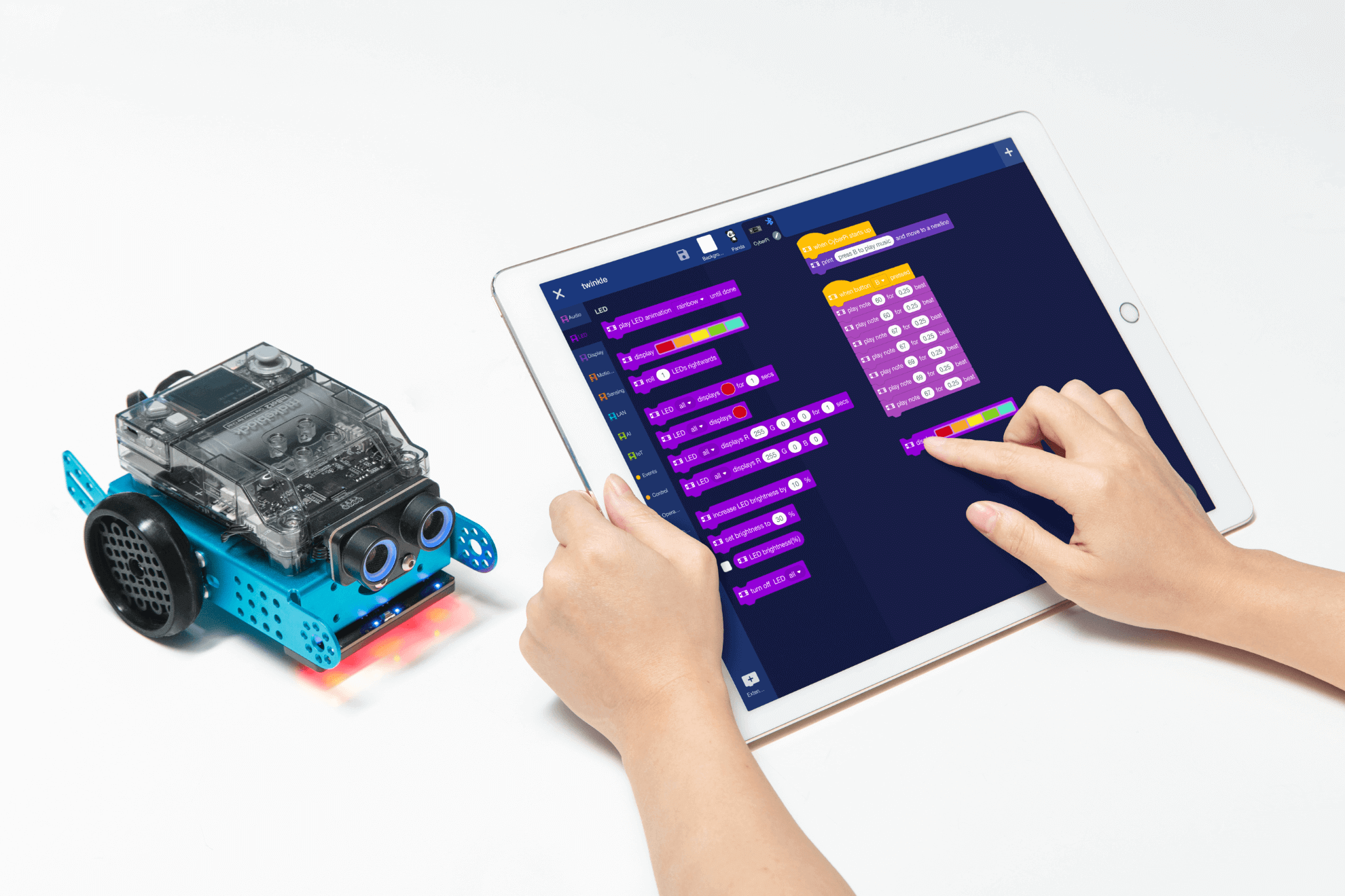 mBot 2 educational robot with CyberPi programming displayed on a tablet, showcasing coding for students.