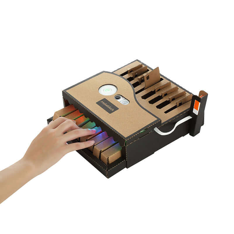 Hand reaching for colorful educational modules in the Makeblock Neuron Explorer Kit, ideal for STEM learning.