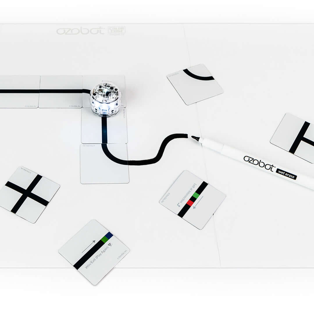 Ozobot Color Code Magnets Base Kit with magnetic board, wet erase marker, and coding puzzle pieces for hands-on learning.