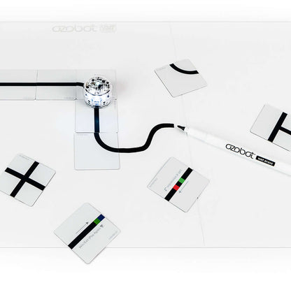 Ozobot Color Code Magnets Base Kit with magnetic board, wet erase marker, and coding puzzle pieces for hands-on learning.