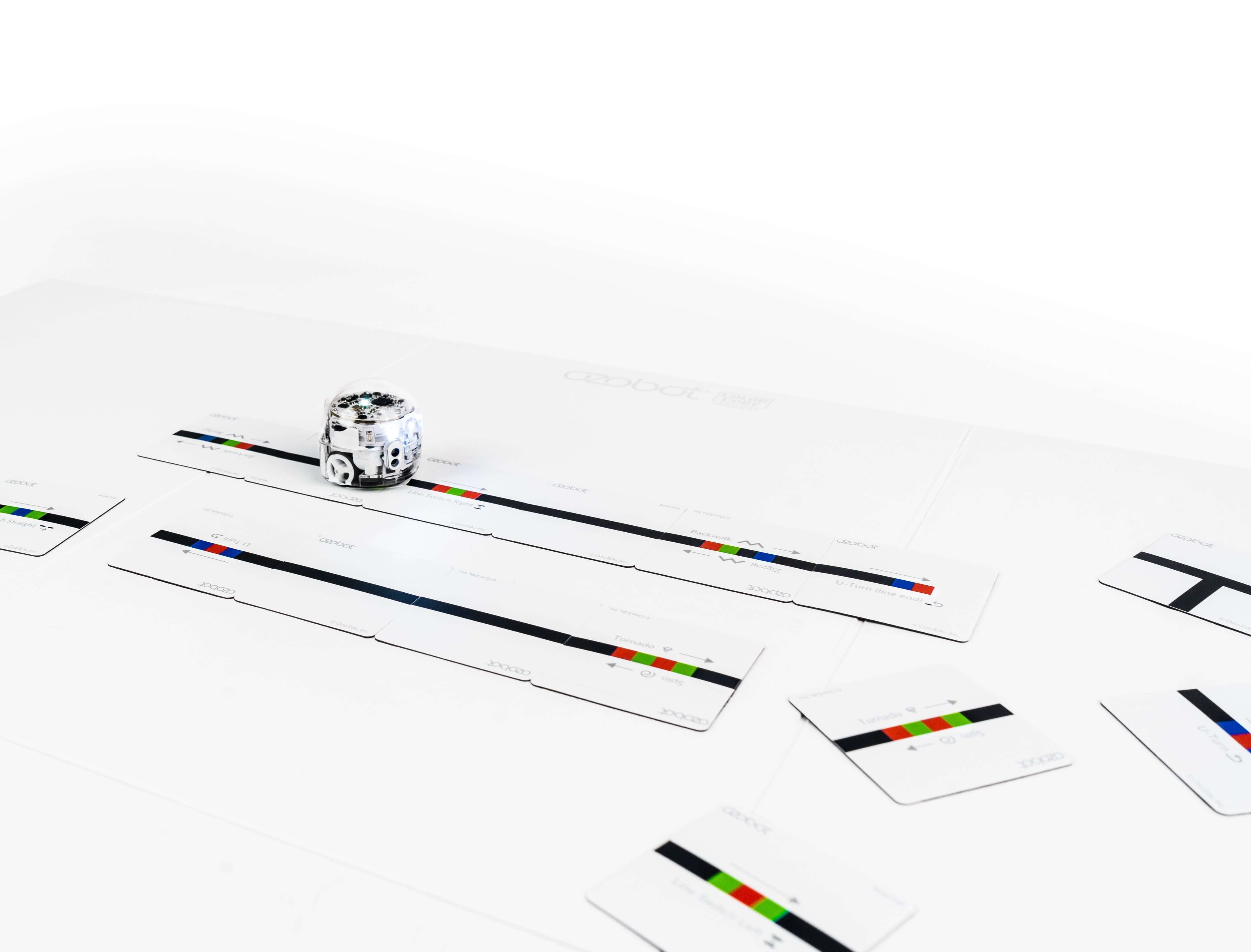 Ozobot Color Code Magnets with Evo robot on a coding mat, showcasing interactive learning and coding principles.
