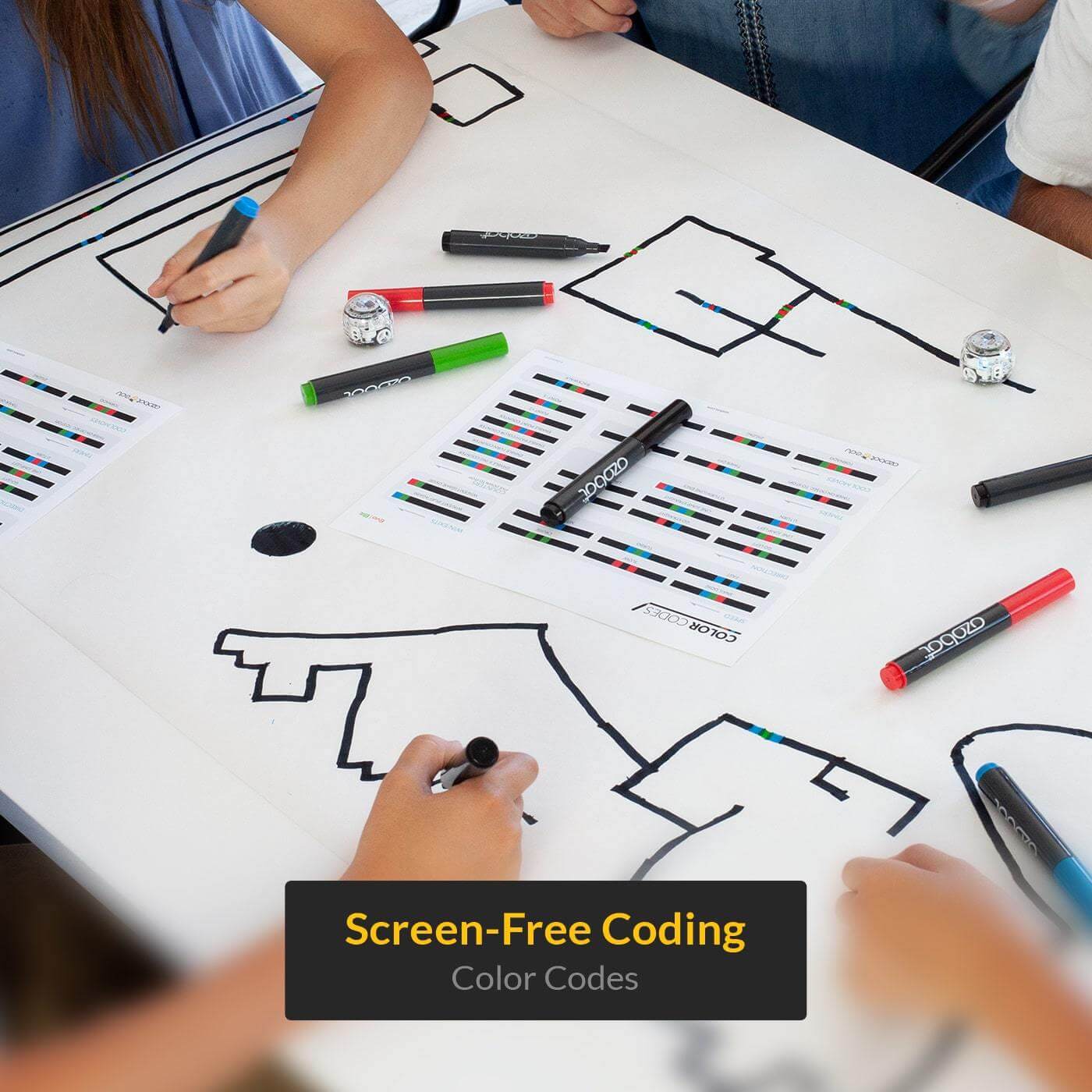 Children engaged in screen-free coding with colorful markers and Ozobot Evo on a drawing board.