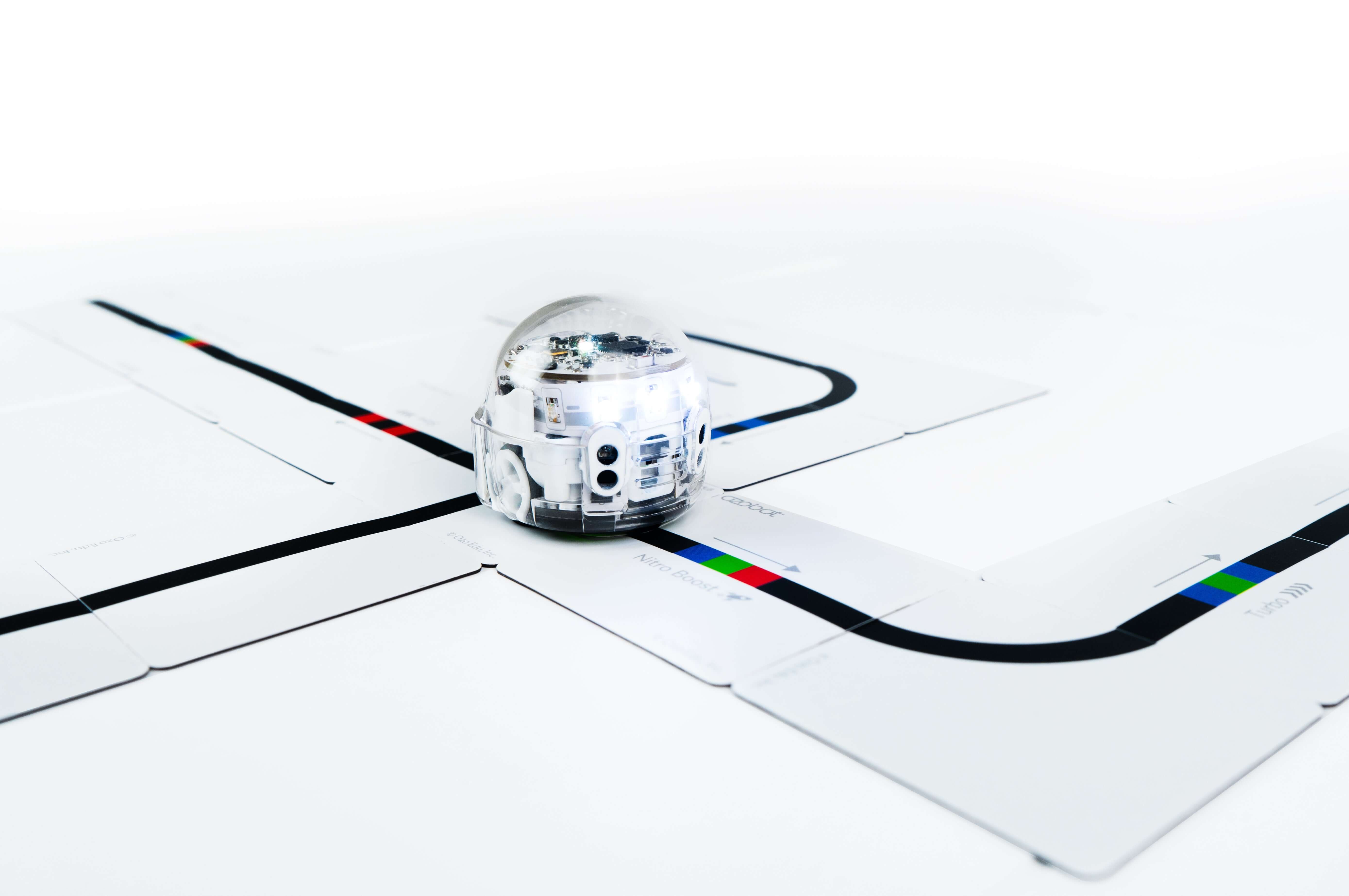 Ozobot Evo robot navigating Color Code Magnets puzzle pieces for interactive coding education.