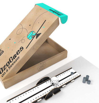 OzoGoes On A Seesaw kit packaging with seesaw apparatus and components for STEAM learning in a classroom setting.