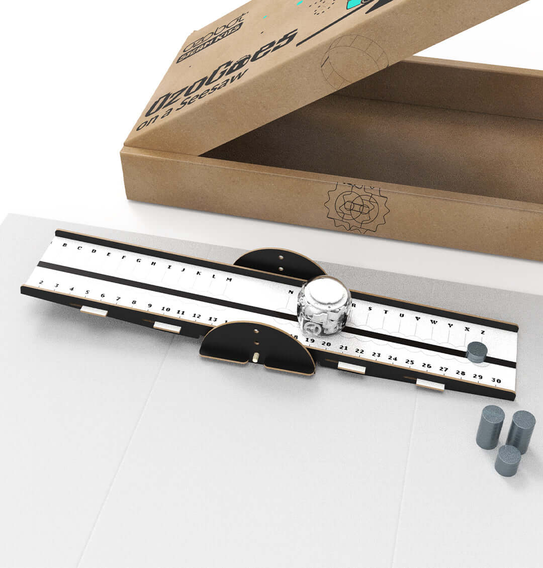 OzoGoes On A Seesaw kit showing the ruler, lever mechanism, and cardboard packaging for STEAM learning.
