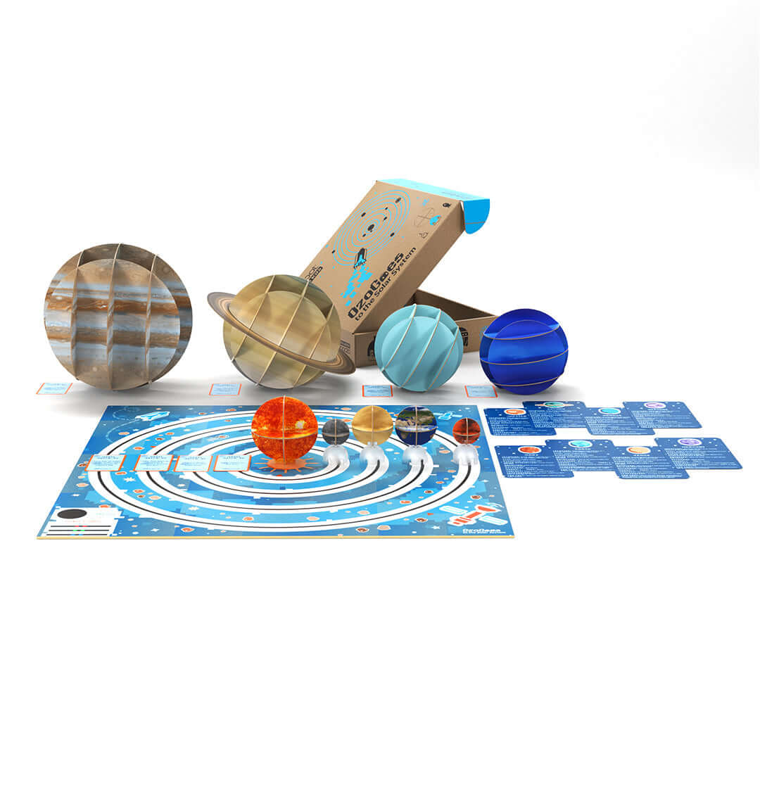 OzoGoes to the Solar System STEAM kit with planet figurines and educational game board for learning activities.