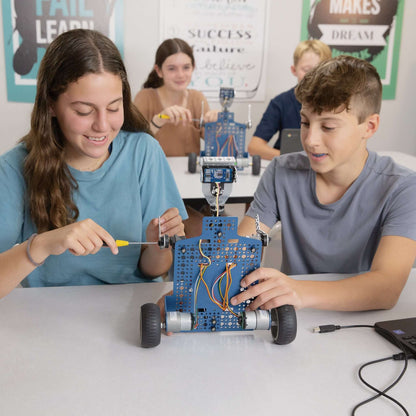 Middle school students engaged in building the Seeker robot, promoting STEM learning and coding skills.