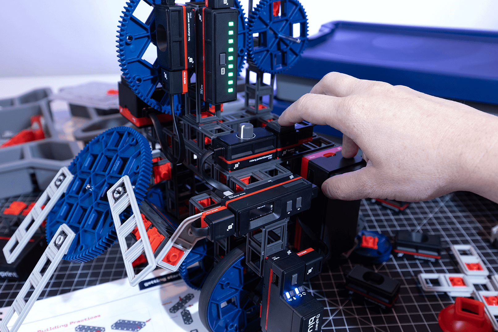 User manipulating components of the Sphero Blueprint Engineering Kit to build a mechanical prototype.