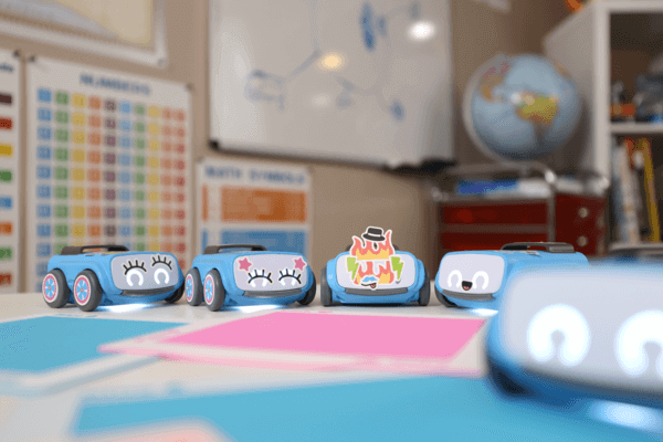 Colorful indi robots placed on a classroom table, ready for STEAM learning activities and computational thinking.
